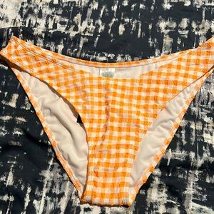 A orange and white low rise bikini bottom